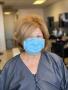 Photograph: [Woman in hair salon wearing a face mask]