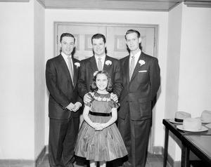 [Photograph of three men and a girl]