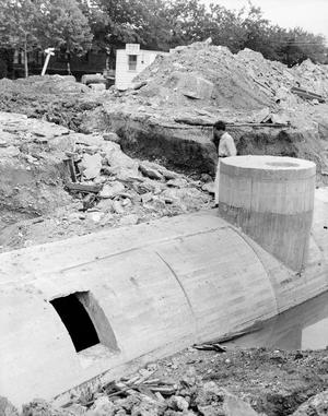 [Photograph of a large concrete pipe]