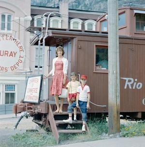 [Carol, Pam and Byrd posing nect to a railroad car]