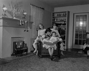 Primary view of object titled '[Doris reading to her children, 3]'.