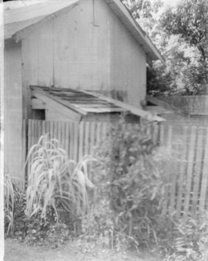 [A wooden shed and fence]