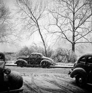 [Three automobiles in the snow]
