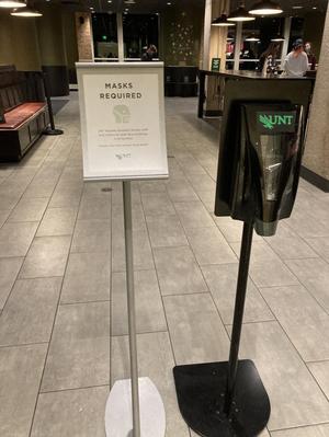[Hand sanitizer and COVID-19 signage in Starbucks on UNT campus]