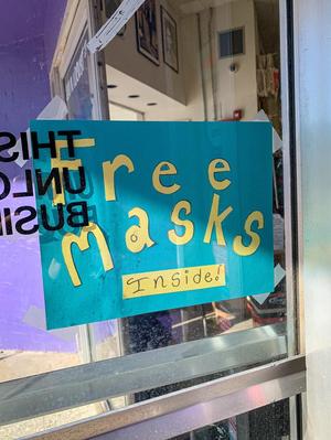 ["Free masks inside" sign in Recycled Books]