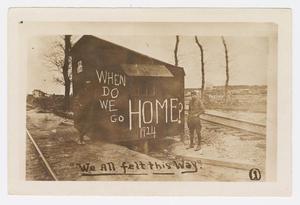 [Photograph of two solders standing by a shack]