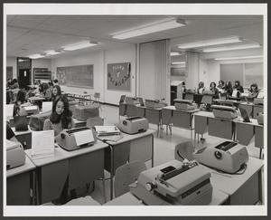 [Plano classroom with typewriters]