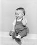 Photograph: [A toddler boy in overalls smiling for picture, 2]