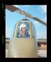 Photograph: [Iranian official sitting in a Cobra helicopter]