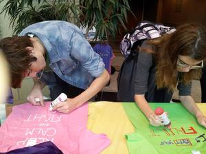 [Two students decorating t-shirts at 2013 Clothesline Project]