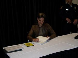 [Woman signing books, 2011 E&D conference]