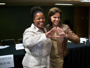 [Two women making triangle with hands, 2011 E&D conference]