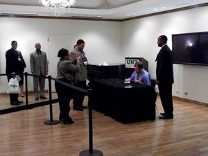 [Tim Wise signing book, 2011 E&D conference]