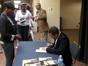 [Hill Harper signing book, 2011 E&D conference]