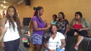 [Women braiding hair at MC event 2]
