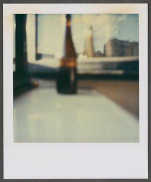 [Blurry photograph of a glass bottle]