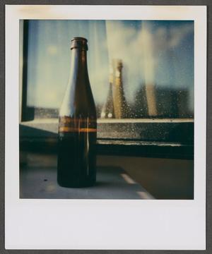 [Blurry photograph of a glass bottle, 2]