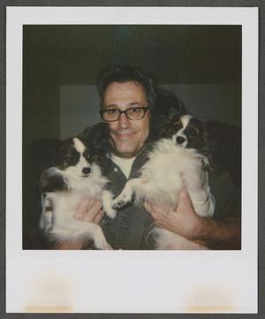 [Byrd Williams IV holding two dogs]