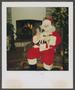 Photograph: [Santa holding a small dog]