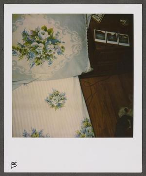 [Bed with floral bedding]