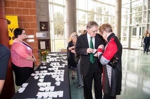 Primary view of object titled '[Guests collecting their name tags at the UNT College of Music Gala]'.