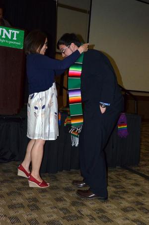 [Student in suit and serape stole, MC ceremony 1]