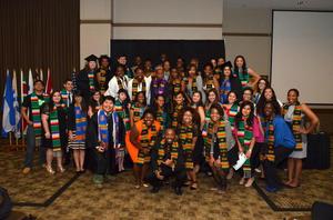 [Group photo of students in stoles, MC ceremony]