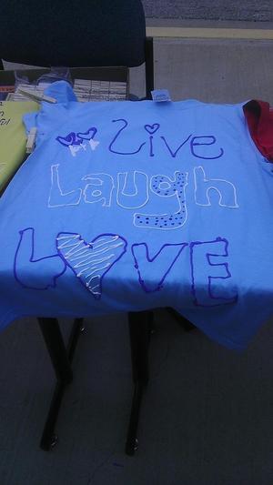 [Message on blue Clothesline Project t-shirt]
