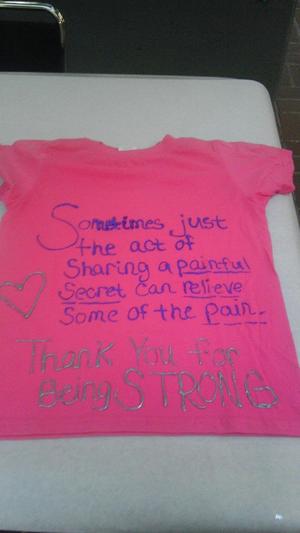 [Message on pink Clothesline Project t-shirt]