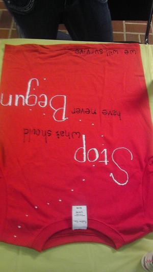 [Message on red Clothesline Project t-shirt]