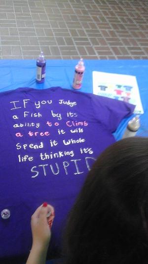 [Message on dark purple Clothesline Project t-shirt]