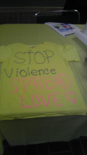 [Message on yellow Clothesline Project t-shirt]