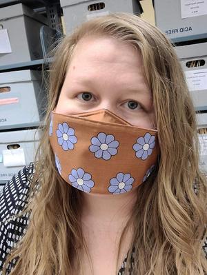 [Katy Allred wearing a face mask at University of Houston Special Collections]