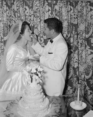 [Robert (Bob) Scarborough feeding cake to his newlywed wife Glenella]
