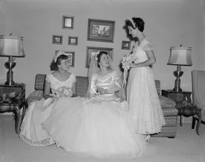 [A bride, Glenella Scarborough, and two of her bridesmaids in a room]