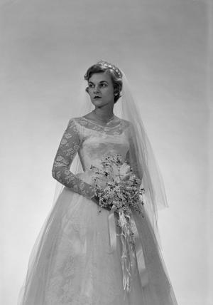 [Portrait of Jane Williams in a wedding dress, holding a bouquet, standing, 8]