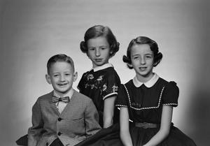 [Portrait of siblings Robert, Ruth, and Nancy Compere, smiling]