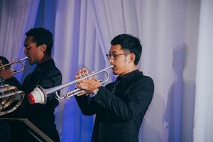 [Two musicians playing trumpets at the reception for the UNT College of Music Gala]