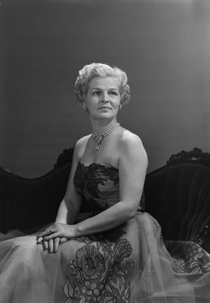 [Portrait of Pauline Belew Leavell in an embellished dress sitting on a couch]