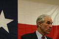 Photograph: [Portrait of Ron Paul in front of Texas flag at campaign rally]