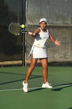 [Idalina Franca hits ball during tennis match]