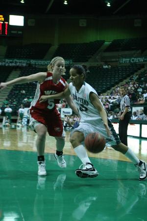[UNT women's basketball player dribbles ball during game, 3]