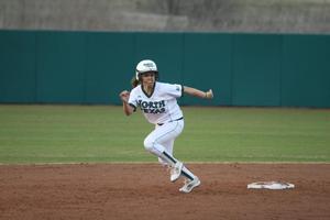 [North Texas softball player runs the bases during game]
