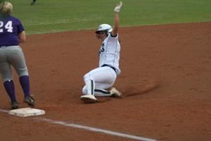 [North Texas softball player slides to base during a game]