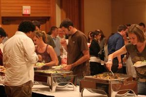 [Photograph of people plating food at murder mystery dinner]