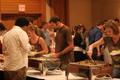 Photograph: [Photograph of people plating food at murder mystery dinner]