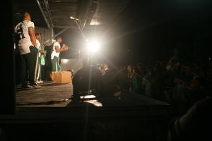 [Photograph of North Texas football players on stage at pep rally]