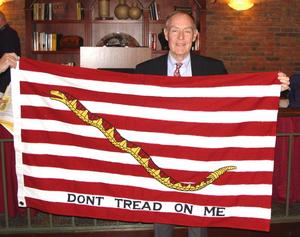 [Man holds 1st Navy Jack flag at TXSSAR Dallas Chapter event]