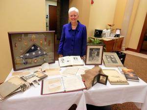 [Marye Scantlin stands behind memorabilia table during TXSSAR Dallas Chapter meeting: February 10, 2018]
