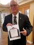 Thumbnail image of item number 1 in: '[Gary Lovell holds event flyer at TXSSAR Dallas Chapter meeting]'.